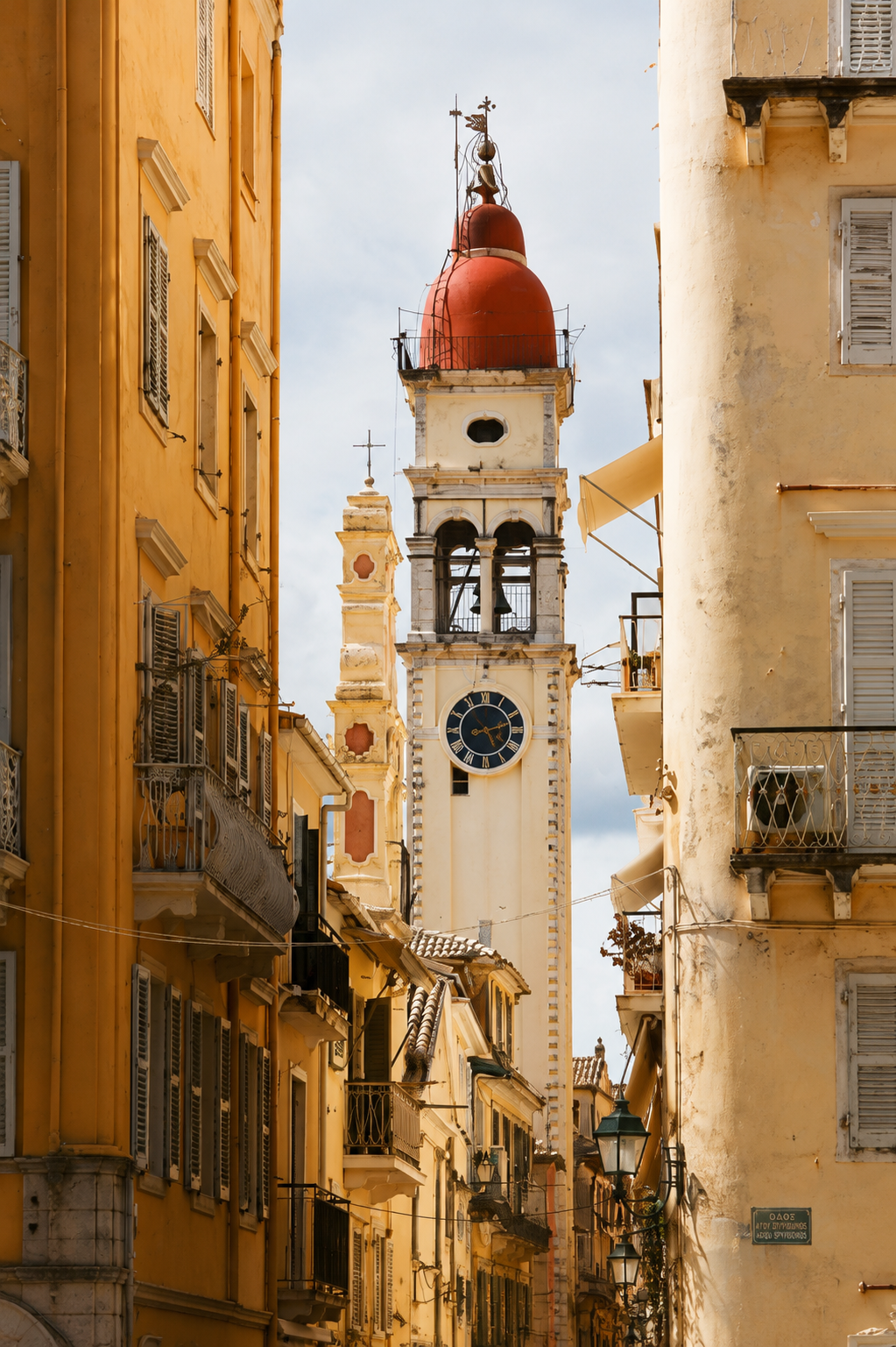 Historic bell tower rising above Corfu old town streets